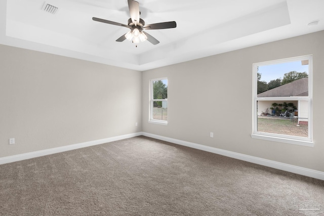 5681 Paddlewheel Dr, Milton, FL 32583 - carpeted empty room featuring a tray ceiling, baseboards, and ceiling fan