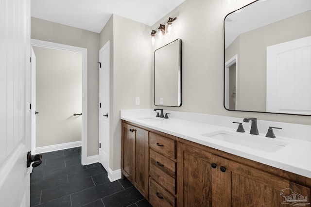 5681 Paddlewheel Dr, Milton, FL 32583 - bathroom featuring double vanity, tile patterned flooring, and baseboards