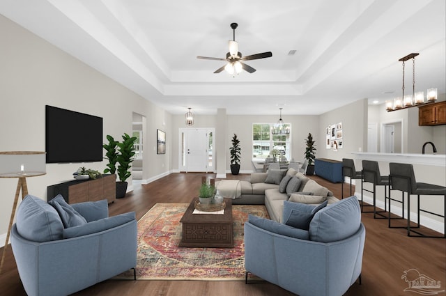 5681 Paddlewheel Dr, Milton, FL 32583 - living area with a raised ceiling, ceiling fan, and dark wood finished floors