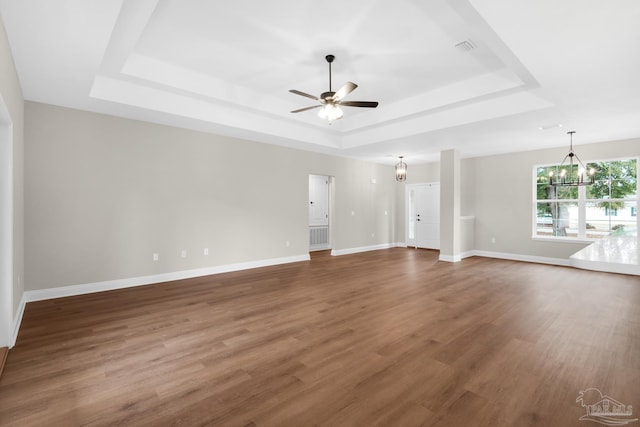 5681 Paddlewheel Dr, Milton, FL 32583 - unfurnished living room with a tray ceiling, ceiling fan, and wood finished floors