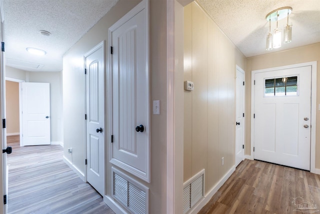 entrance foyer with hardwood / wood-style flooring and a textured ceiling