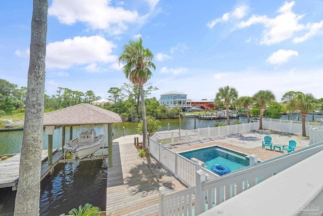 view of swimming pool with a dock and a water view