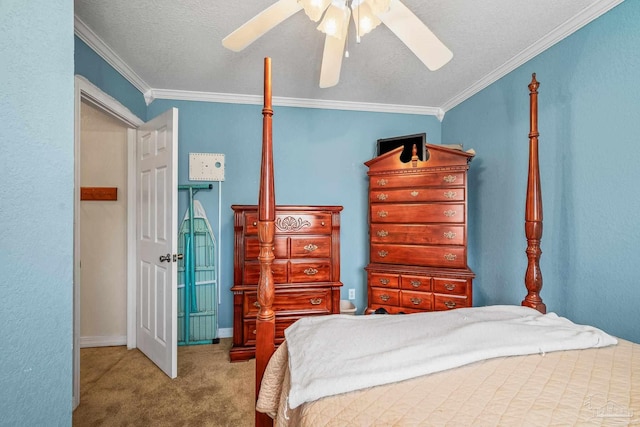 carpeted bedroom with ornamental molding, a textured ceiling, and a ceiling fan