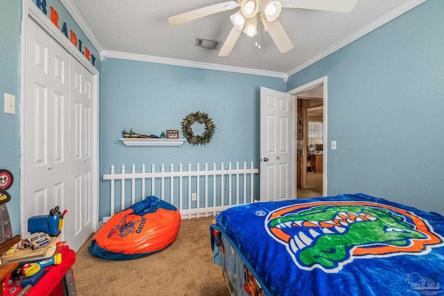 bedroom with a closet, visible vents, crown molding, and carpet flooring