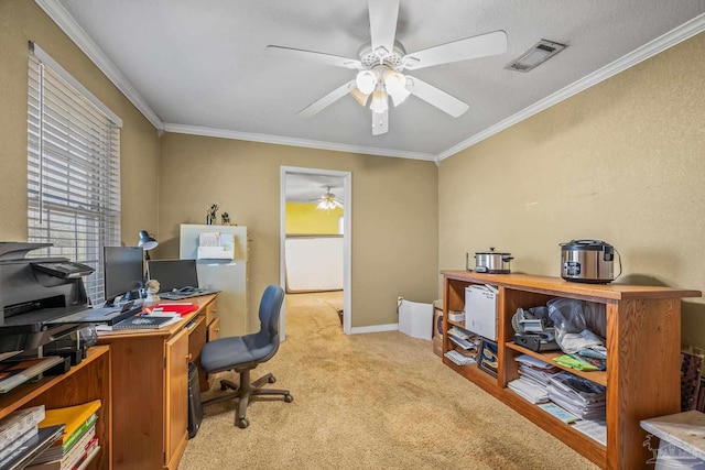 office area with a ceiling fan, visible vents, crown molding, and light colored carpet