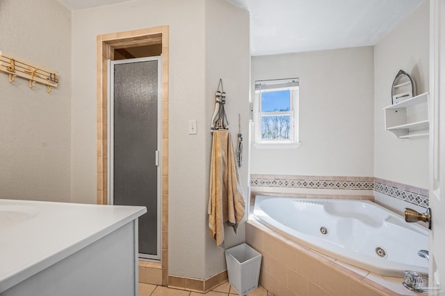 full bathroom with a jetted tub, a stall shower, and tile patterned floors