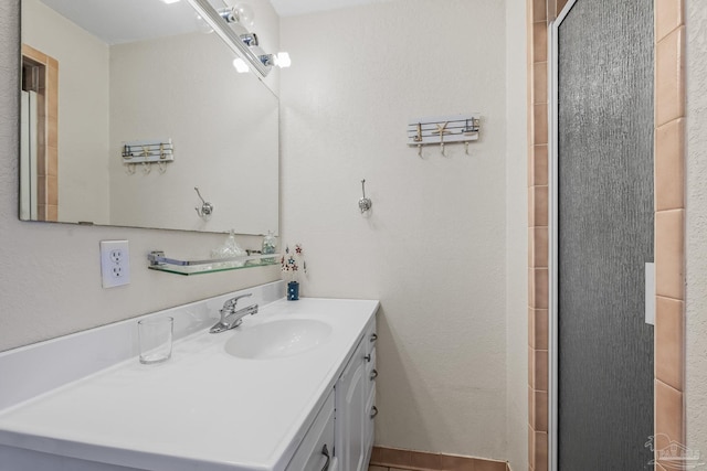 full bathroom with a shower with shower door and vanity