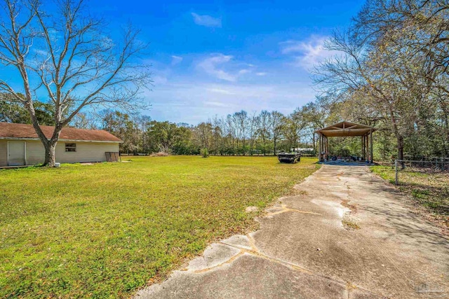 view of yard with driveway and a carport