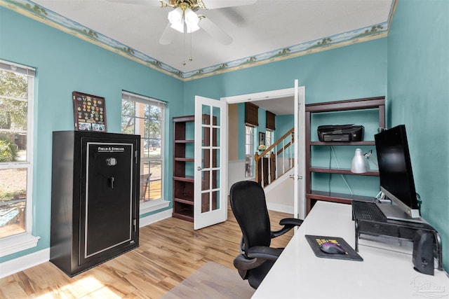 home office featuring ceiling fan, baseboards, wood finished floors, and french doors