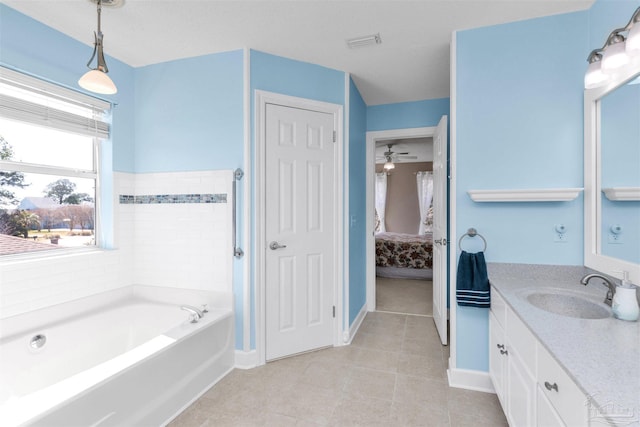 ensuite bathroom featuring visible vents, connected bathroom, vanity, tile patterned flooring, and a bath