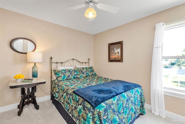 bedroom featuring a ceiling fan, carpet, and baseboards