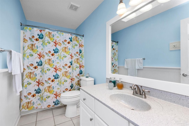 full bathroom featuring visible vents, toilet, curtained shower, tile patterned flooring, and vanity