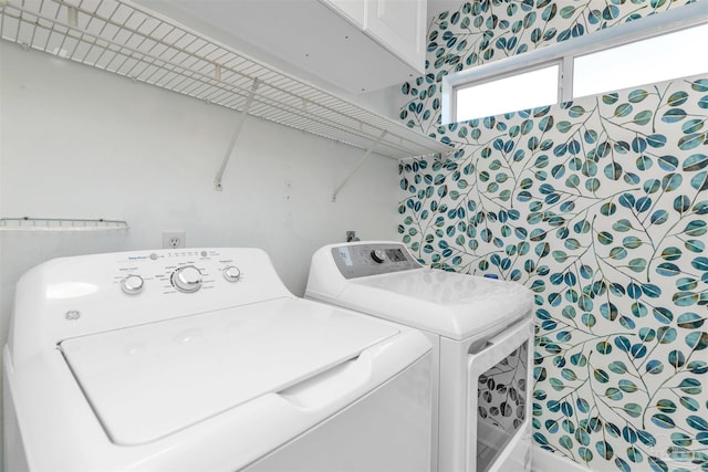 washroom featuring cabinet space and washing machine and clothes dryer