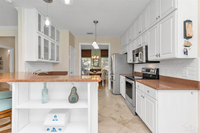 kitchen featuring stainless steel appliances, backsplash, glass insert cabinets, white cabinets, and a peninsula