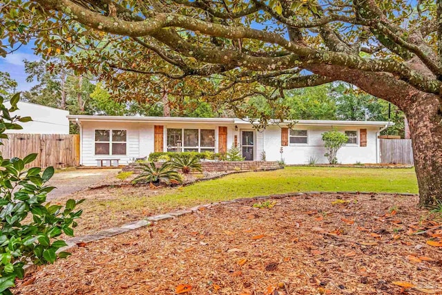 ranch-style house with a front lawn