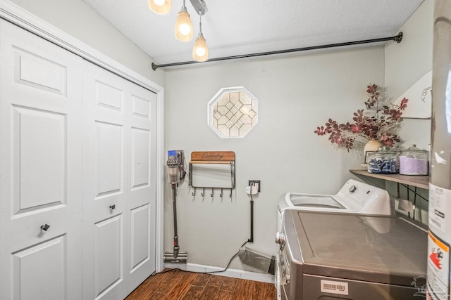 washroom featuring washer and clothes dryer, dark wood-type flooring, and a textured ceiling