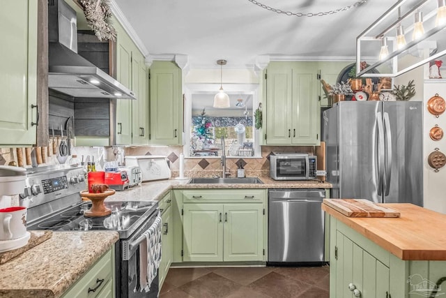 kitchen with wall chimney exhaust hood, green cabinets, sink, and stainless steel appliances