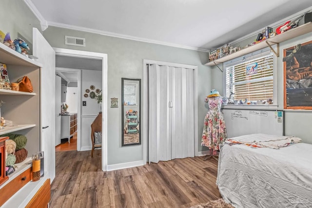 bedroom featuring hardwood / wood-style floors and crown molding