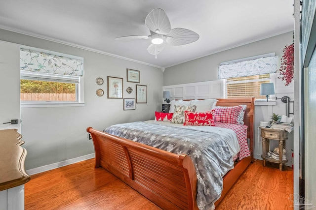 bedroom featuring hardwood / wood-style floors, ceiling fan, and ornamental molding