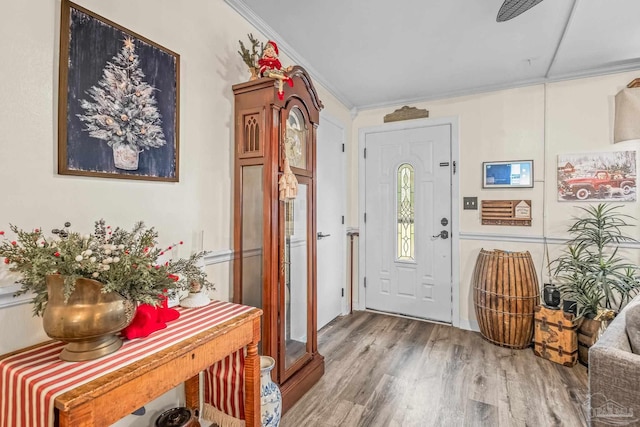 entryway featuring hardwood / wood-style floors and crown molding