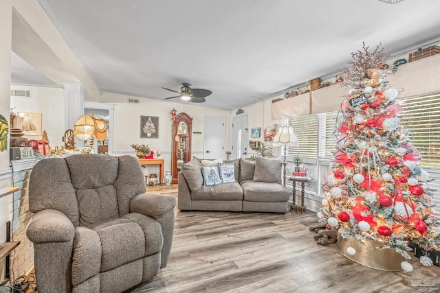 living room with light wood-type flooring, vaulted ceiling, and ceiling fan