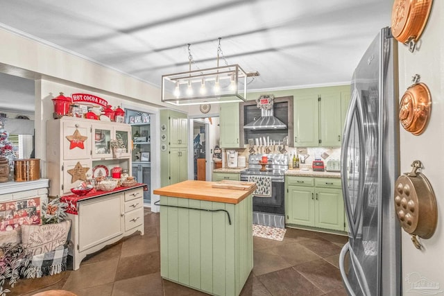 kitchen featuring wall chimney exhaust hood, green cabinets, a kitchen island, and stainless steel appliances