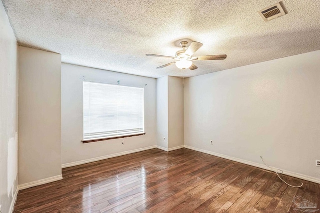 unfurnished room with ceiling fan, dark hardwood / wood-style flooring, and a textured ceiling