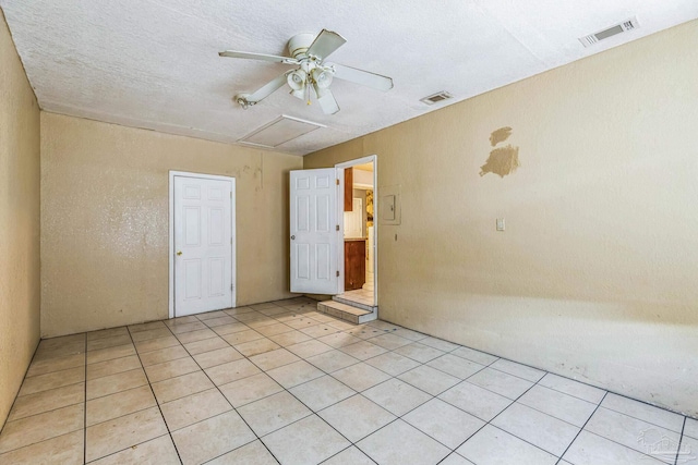 tiled spare room with ceiling fan