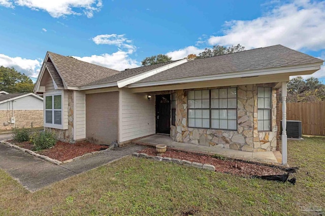 ranch-style home with central AC and a front yard