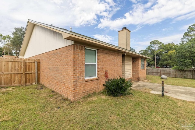 view of side of home featuring a lawn