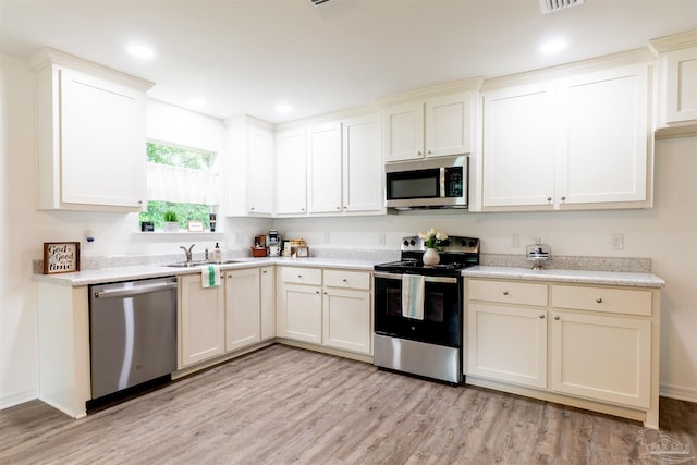 kitchen featuring sink, light wood-type flooring, and appliances with stainless steel finishes