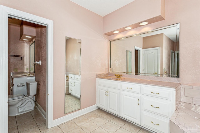 bathroom featuring vanity, tile patterned flooring, and toilet