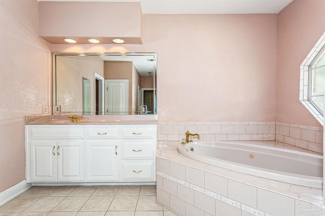 bathroom featuring tile patterned flooring, vanity, and a relaxing tiled tub