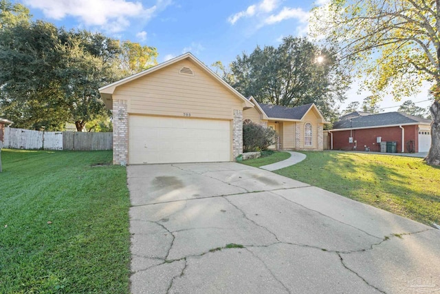 ranch-style house featuring a front yard and a garage