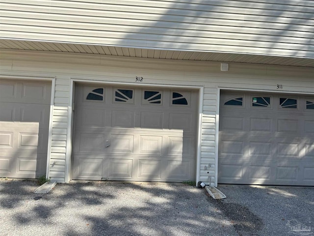 garage featuring wooden walls