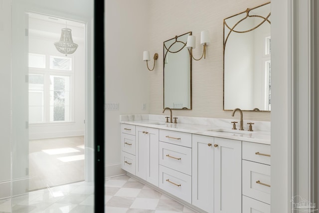 full bath featuring tile patterned floors, a sink, baseboards, and double vanity