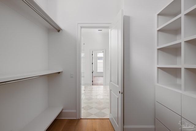 spacious closet with wood finished floors