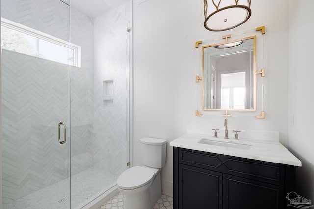 full bath featuring vanity, toilet, and a shower stall