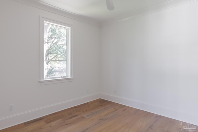 empty room featuring ceiling fan, wood finished floors, and baseboards