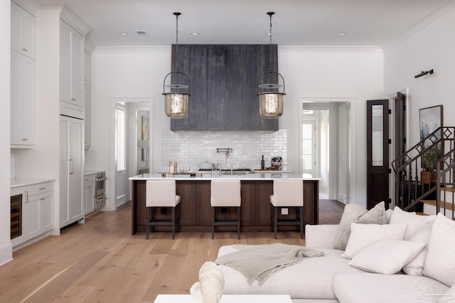 kitchen with light countertops, a breakfast bar, and decorative light fixtures