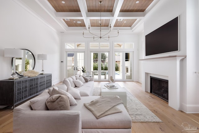 living room with coffered ceiling, a towering ceiling, light wood-style flooring, wood ceiling, and beamed ceiling