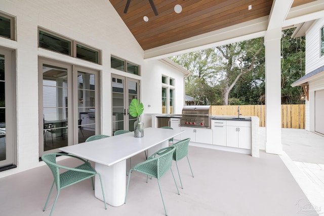 view of patio / terrace featuring area for grilling, a sink, a grill, a ceiling fan, and fence