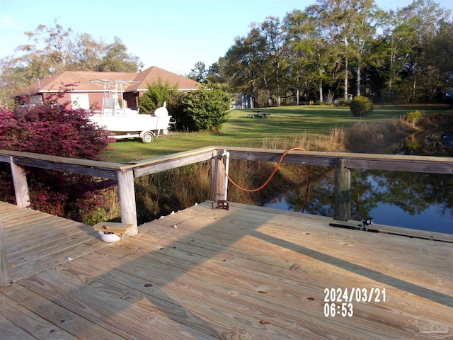 view of dock with a yard