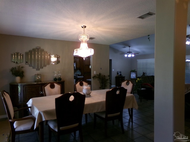 dining room with ceiling fan, a textured ceiling, and tile patterned floors