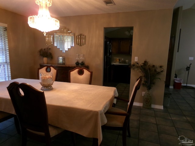 tiled dining space with an inviting chandelier