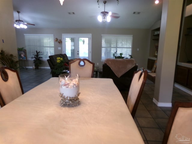 tiled dining room with ceiling fan and french doors