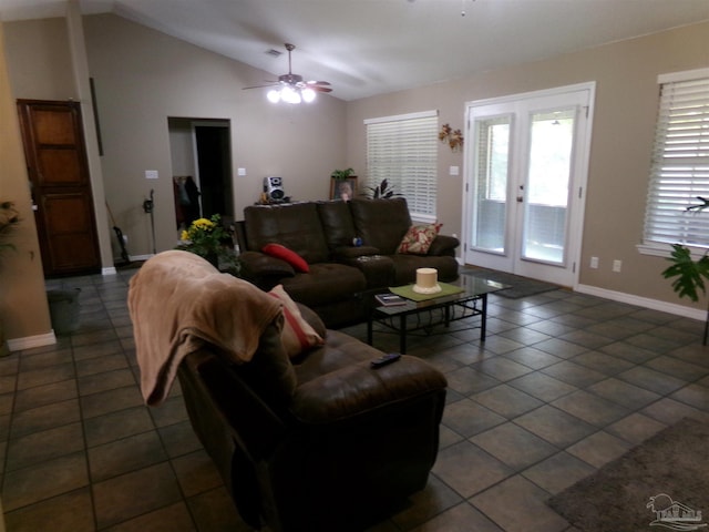 living room featuring ceiling fan, dark tile patterned flooring, and lofted ceiling