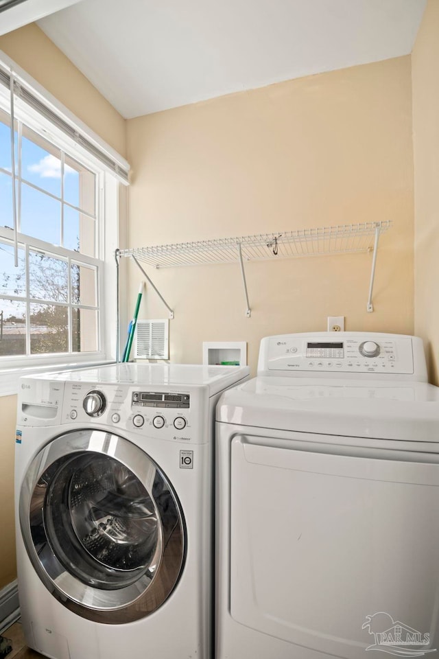 laundry room featuring separate washer and dryer