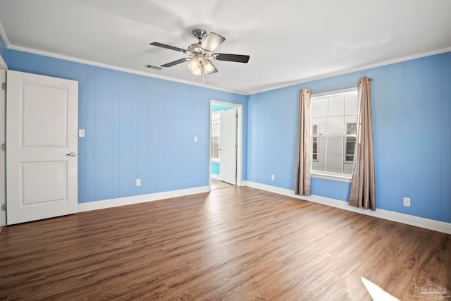 empty room featuring ceiling fan, crown molding, and hardwood / wood-style flooring