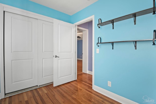 unfurnished bedroom with hardwood / wood-style flooring and a closet